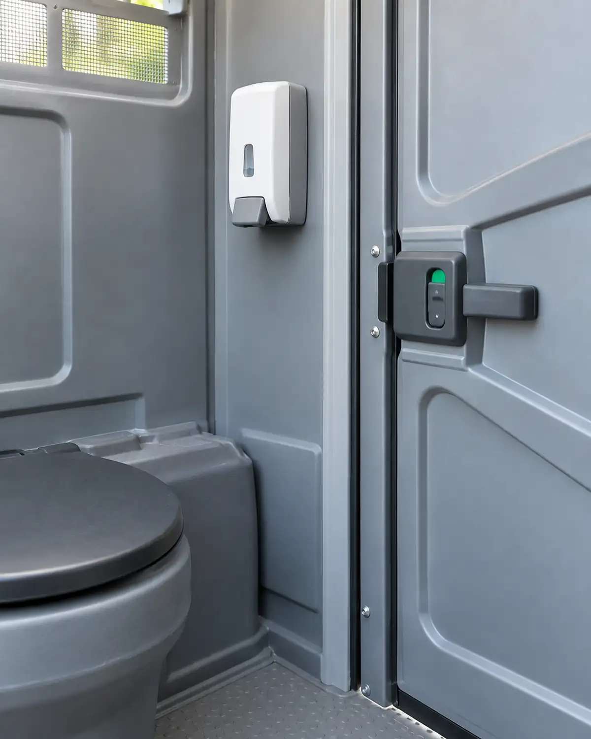 Illustrative clean portable restroom doorway with a sanitizer dispenser